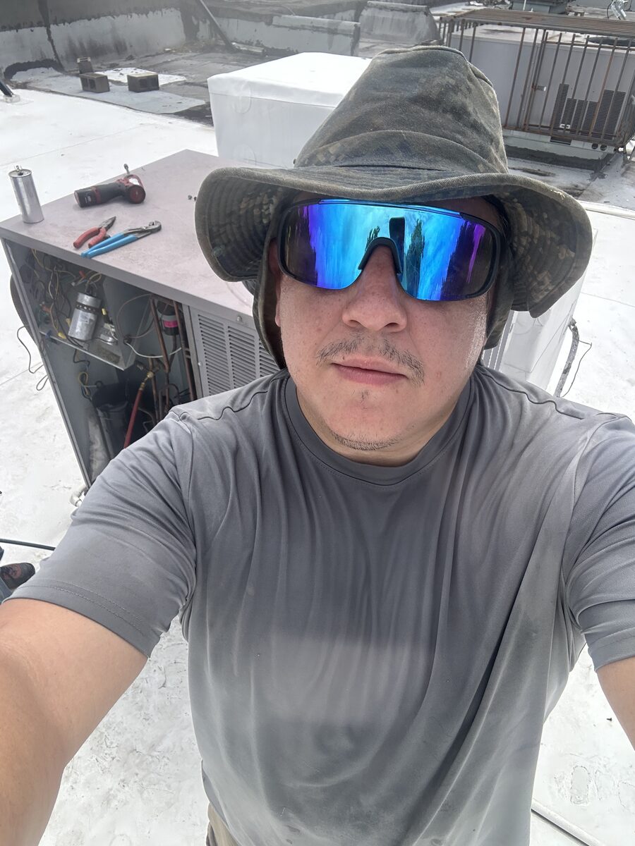 A Ferre technician on a Houston rooftop during a job