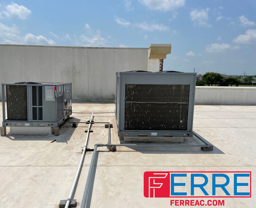 Two packaged rooftop units on a Houston roof, marked with the Ferre name