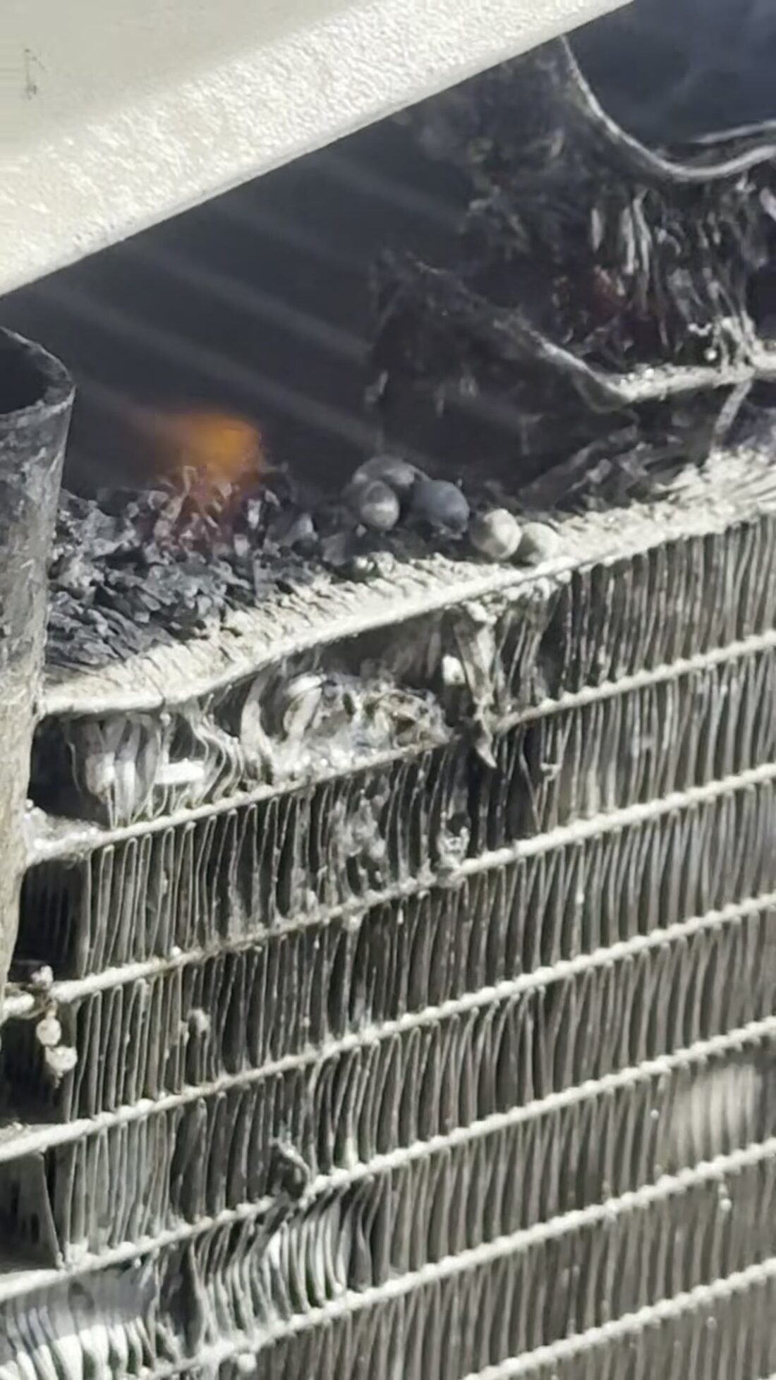 Torch on the coil, chasing a leak.