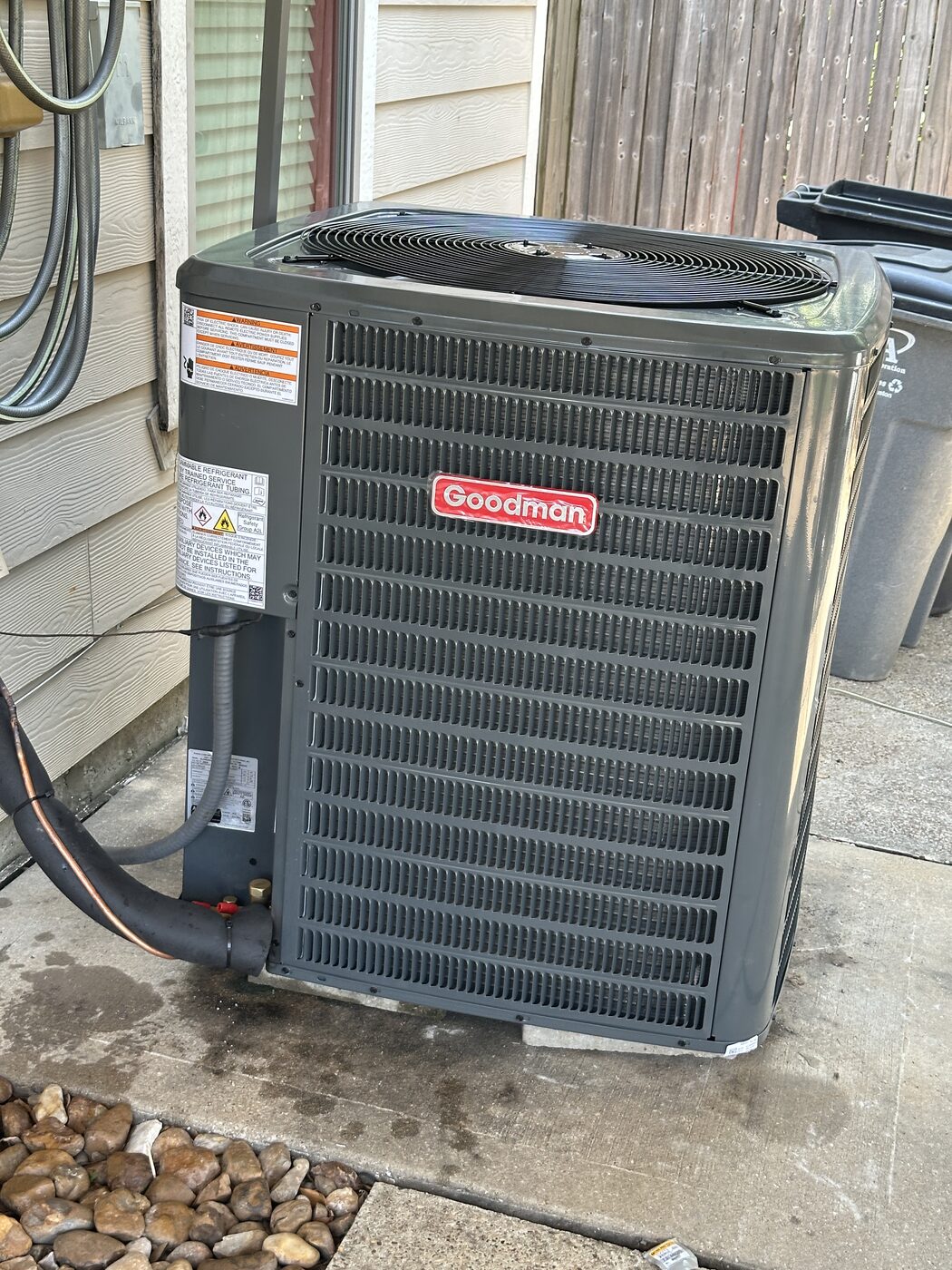 A residential outdoor condensing unit beside a house